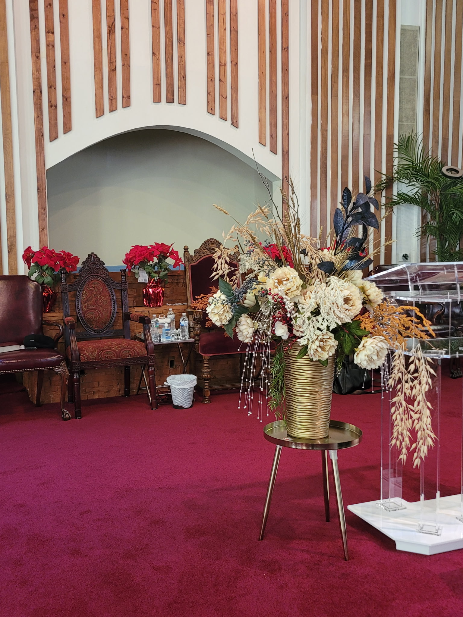 Floral and seating details on the church stage